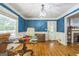 Traditional dining room with a large window, hardwood floors, and blue textured walls at 2201 Valley Creek Cir, Snellville, GA 30078