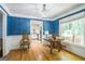 Dining room featuring blue walls, hardwood flooring, and decorative light fixture at 2201 Valley Creek Cir, Snellville, GA 30078