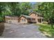 Inviting two-story home with a spacious driveway and attached two-car garage, set amidst lush greenery at 2201 Valley Creek Cir, Snellville, GA 30078