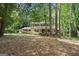 Charming two-story home featuring yellow siding, front porch, and manicured landscaping at 2201 Valley Creek Cir, Snellville, GA 30078