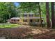 Charming two-story home featuring yellow siding, front porch, and manicured landscaping at 2201 Valley Creek Cir, Snellville, GA 30078