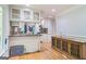 Open-concept kitchen with white cabinetry, granite countertops, and wood floors at 2201 Valley Creek Cir, Snellville, GA 30078