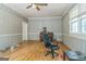 Room features wood paneling, hardwood floors, a piano, and natural lighting at 2201 Valley Creek Cir, Snellville, GA 30078