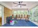 Relaxing sunroom with ceiling fan, blue carpet and screened windows offering wooded view at 2201 Valley Creek Cir, Snellville, GA 30078