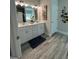 Stylish bathroom featuring double sinks, framed mirrors and luxury vinyl plank flooring at 3006 Fairway Dr, Villa Rica, GA 30180