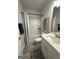 Clean bathroom with tub and shower combination with luxury vinyl plank flooring and neutral paint at 3006 Fairway Dr, Villa Rica, GA 30180