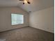 Bedroom featuring vaulted ceilings, neutral carpet, and natural light from a window at 7090 E Village Ct, Riverdale, GA 30296