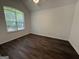 Bright bedroom with hardwood floors, a ceiling fan, and a large window at 7090 E Village Ct, Riverdale, GA 30296