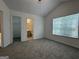 Bedroom with vaulted ceiling featuring entrances to a closet and bathroom at 7090 E Village Ct, Riverdale, GA 30296