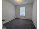 Bedroom featuring neutral carpet and a window at 7090 E Village Ct, Riverdale, GA 30296