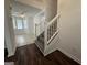 Inviting entryway with hardwood floors and staircase leading to the upper level at 7090 E Village Ct, Riverdale, GA 30296