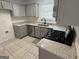 Stylish kitchen featuring stainless steel appliances, granite countertops, and ample cabinet space at 7090 E Village Ct, Riverdale, GA 30296