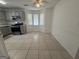 Open kitchen with tile floors, stainless steel appliances, and eat-in area at 7090 E Village Ct, Riverdale, GA 30296