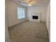 Cozy living room featuring a white brick fireplace and ample natural light from a large window at 7090 E Village Ct, Riverdale, GA 30296