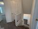Staircase featuring carpeted steps and white railing that leads to the lower level at 7090 E Village Ct, Riverdale, GA 30296