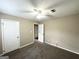 Bedroom featuring ceiling fan, neutral paint, with doors leading to closet and other rooms at 6309 Wellington Way, Austell, GA 30106