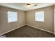 Bright bedroom with neutral walls, carpet flooring, and natural light from two windows at 6309 Wellington Way, Austell, GA 30106