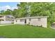Charming single-story home with lush green lawn and mature trees, providing great curb appeal at 6309 Wellington Way, Austell, GA 30106