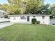Inviting single-story home with well-maintained lawn and mature trees, showcasing its cozy charm at 6309 Wellington Way, Austell, GA 30106