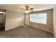 Bright living room featuring a ceiling fan, carpeted floors, and access to the front door at 6309 Wellington Way, Austell, GA 30106
