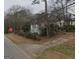 Exterior view of a quaint home, with weathered siding, nestled among trees and utility poles, needs renovation at 2010 Mcafee Pl, Decatur, GA 30032