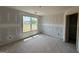 Bright, unfinished bedroom with large window and natural light at 242 Old Jackson Rd, Mcdonough, GA 30252