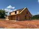 New two-story home under construction shows exposed framework and covered front porch at 242 Old Jackson Rd, Mcdonough, GA 30252
