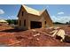 New home under construction shows exposed framework and a large opening for a garage at 242 Old Jackson Rd, Mcdonough, GA 30252