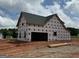 New construction home with garage and a gabled roof, plus windows already installed at 242 Old Jackson Rd, Mcdonough, GA 30252