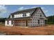 Two-story new construction home featuring a gabled roof, covered porch, and many windows at 242 Old Jackson Rd, Mcdonough, GA 30252