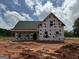 New construction home featuring a gabled roof, covered porch, and windows installed at 242 Old Jackson Rd, Mcdonough, GA 30252