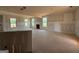 Unfinished living room with bright, light-filled windows and a cozy fireplace ready for customization at 242 Old Jackson Rd, Mcdonough, GA 30252