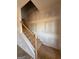 Unfinished staircase with wood handrail and temporary treads at 242 Old Jackson Rd, Mcdonough, GA 30252