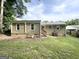 Backyard view of a house featuring a mixture of brick and wood siding with multiple entrances at 2851 Mitchell Dr, Decatur, GA 30032