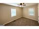 Bright bedroom with two windows, neutral carpet, and a ceiling fan at 2851 Mitchell Dr, Decatur, GA 30032