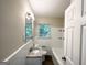 Well-lit bathroom with granite vanity, white tile, and shower-tub combo at 2215 Rosewood Rd, Decatur, GA 30032