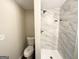 Bathroom featuring new shower, sleek toilet, with clean, modern design at 2215 Rosewood Rd, Decatur, GA 30032