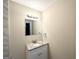 Bathroom boasts a vanity with granite countertop and modern light fixture above the mirror at 2215 Rosewood Rd, Decatur, GA 30032