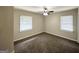 Spacious bedroom with neutral walls, carpet, and two windows at 2215 Rosewood Rd, Decatur, GA 30032
