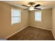 Cozy bedroom featuring neutral walls, carpet, and a ceiling fan for added comfort at 2215 Rosewood Rd, Decatur, GA 30032