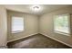 A cozy bedroom with neutral walls and two windows at 2215 Rosewood Rd, Decatur, GA 30032