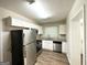 Modern kitchen with stainless steel appliances and white cabinetry at 2215 Rosewood Rd, Decatur, GA 30032