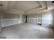 Spacious unfinished bedroom showing tray ceiling, doorway, and blank walls at 252 Old Jackson Rd, Mcdonough, GA 30252