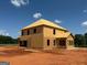 This is a two-story home in the framing stage of construction with a plywood exterior on a dirt lot at 252 Old Jackson Rd, Mcdonough, GA 30252