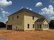 Back exterior of a yellow two-story home showing roof and sunroom at 252 Old Jackson Rd, Mcdonough, GA 30252