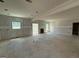 Bright, unfinished living room with two windows and door openings, presenting a spacious layout at 252 Old Jackson Rd, Mcdonough, GA 30252