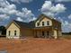 Charming new construction with light yellow siding, black roof, and white windows at 1916 King Mill Rd, Mcdonough, GA 30252