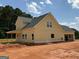 New construction showcasing yellow siding, black roof, and white trim, offering a modern, appealing aesthetic at 1916 King Mill Rd, Mcdonough, GA 30252