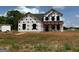 New two-story home under construction with protective wrap in a spacious, open lot at 1916 King Mill Rd, Mcdonough, GA 30252