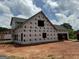 A two-story house under construction featuring unfinished garage and porch framing at 1916 King Mill Rd, Mcdonough, GA 30252